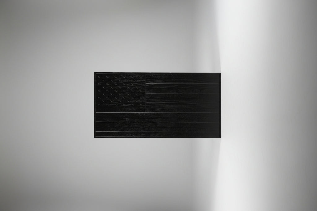 Black textured panel on a wooden surface