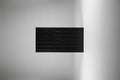 Black textured panel on a wooden surface