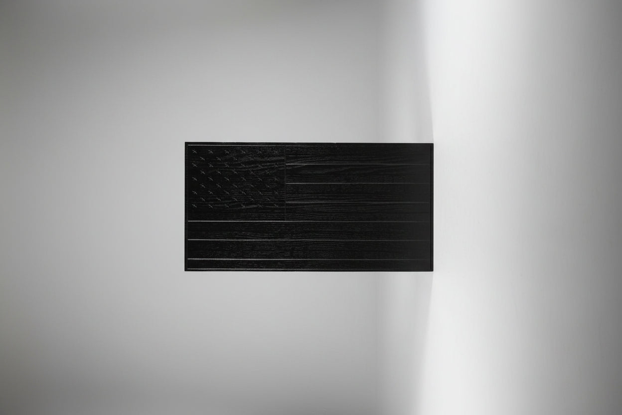 Black textured panel on a wooden surface
