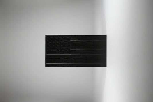 Black textured panel on a wooden surface