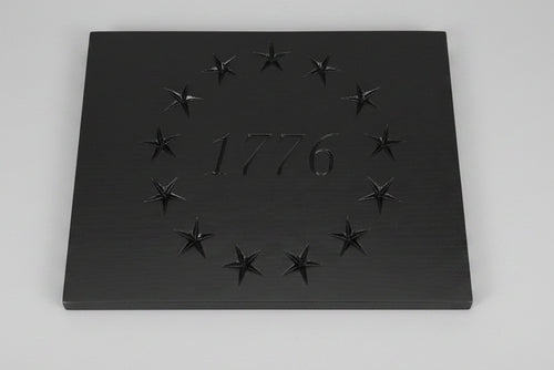 Black plaque with engraved stars and '1776' on a wooden surface with 'Woodworkers' branding.